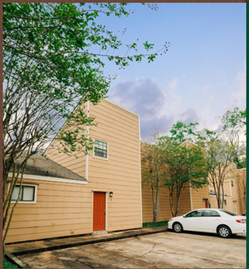 Hammond apartment for rent - a yellow house with a red door and a white car parked outside