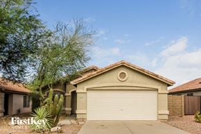Mesa house for rent - a house with a garage and a tree in front of it