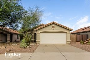 Mesa house for rent - a house with a driveway and a garage door