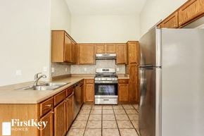 Mesa house for rent - a kitchen with wooden cabinets and stainless steel appliances