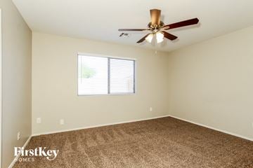Mesa house for rent - a living room with carpet and a ceiling fan