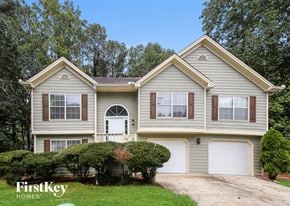 Lawrenceville house for rent - a house with two garage doors and a driveway