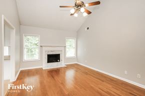 Lawrenceville house for rent - a living room with a fireplace and a ceiling fan