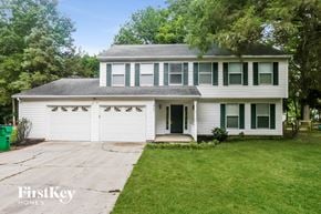 Charlotte house for rent - a white house with a driveway and a white garage door