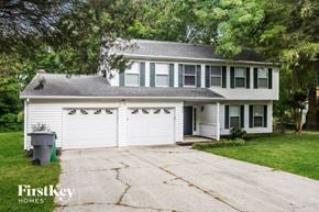 Charlotte house for rent - a white house with a white garage door and a driveway