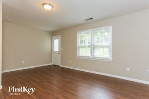 Powder Springs house for rent - A room with wooden floors and a window with blinds.