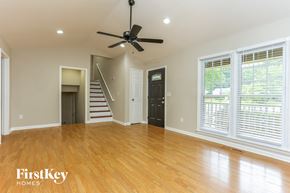 Powder Springs house for rent - A spacious room with a ceiling fan and wooden flooring.