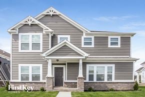 Avon house for rent - a gray house with white trim and a black door