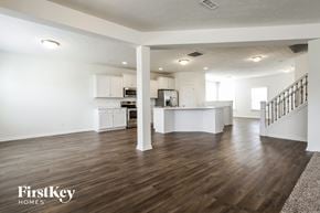 Avon house for rent - a renovated living room and kitchen with white walls and wood floors