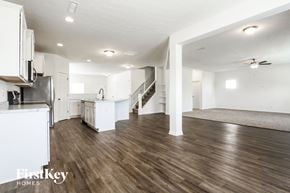 Avon house for rent - a renovated living room and kitchen with white walls and wood flooring
