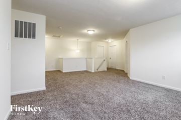 Avon house for rent - a spacious living room with carpet and white walls