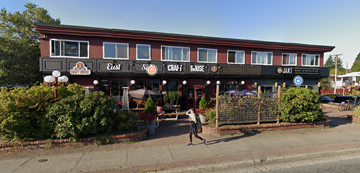 Vancouver apartment for rent - A restaurant with a red and black signboard and a person walking in front.