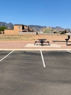 Sierra Vista apartment for rent - A parking lot with a picnic table and benches in the middle.