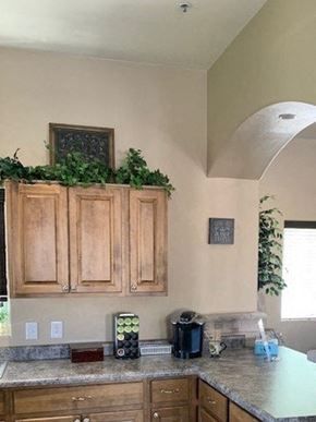 Sierra Vista apartment for rent - A kitchen with wooden cabinets and a green plant on top.