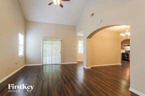 Conroe house for rent - an empty living room with wood flooring and a ceiling fan