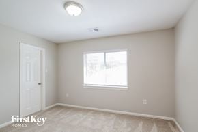 Conroe house for rent - a bedroom with a window and a white door