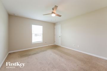 Cape Coral house for rent - a spacious living room with carpet and a ceiling fan