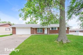 Saint Louis house for rent - a brick house with a large tree in the front