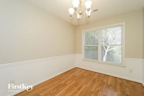 Greensboro house for rent - A room with wooden floors and a chandelier.
