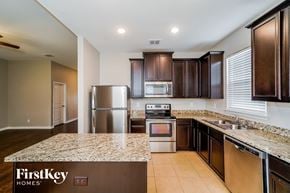 San Antonio house for rent - a kitchen with granite counter tops and stainless steel appliances