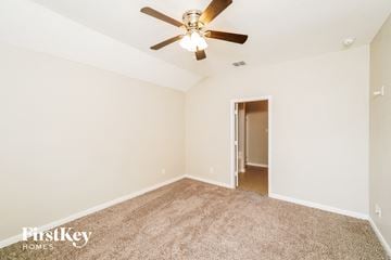 San Antonio house for rent - a spacious living room with carpet and a ceiling fan