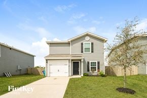 Cove house for rent - a gray house with a white garage door and a lawn