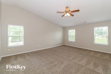 Ball Ground house for rent - a living room with carpet and a ceiling fan