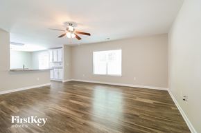 Lexington house for rent - a living room with wood floors and a ceiling fan