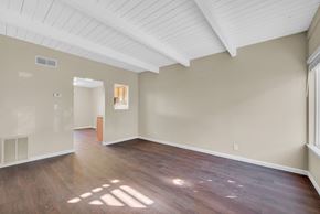 Vacaville apartment for rent - the living room and dining room of an empty house with wood flooring