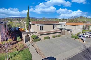 Vacaville apartment for rent - an aerial view of a house with a parking lot and a driveway