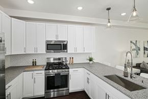 Philadelphia apartment for rent - a kitchen with white cabinets and stainless steel appliances