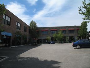 Chicago apartment for rent - an empty parking lot in front of a brick building