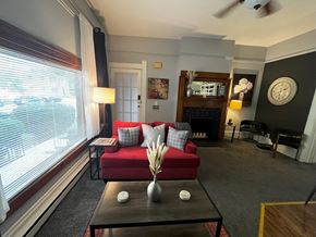 Fort Wayne apartment for rent - a living room with a red couch and a large window