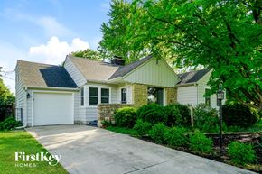 Columbus house for rent - a white house with a driveway and a tree
