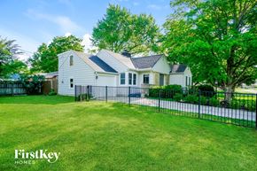 Columbus house for rent - a white house with a black fence in front of a yard