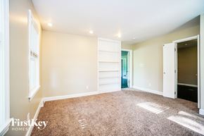 Columbus house for rent - a living room with a carpeted floor and a door to a closet
