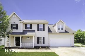 Winston-Salem house for rent - A two-story house with a white garage door and black shutters.