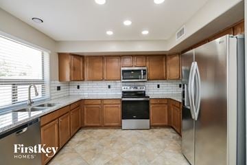 San Tan Valley house for rent - A kitchen with wooden cabinets and stainless steel appliances.