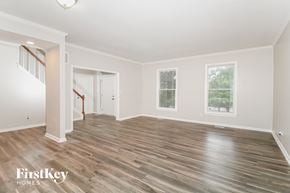 Greensboro house for rent - the living room with hardwood floors and a staircase