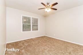 Greensboro house for rent - a bedroom with carpet and a ceiling fan