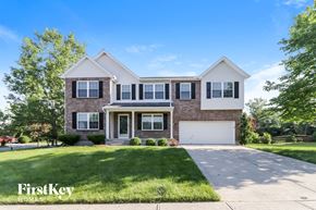 Milford house for rent - a brick house with a white garage door and a lawn