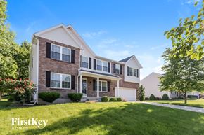 Milford house for rent - a brick house with white shutters and a lawn