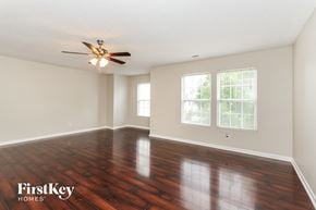 Mount Holly house for rent - an empty living room with wood floors and a ceiling fan