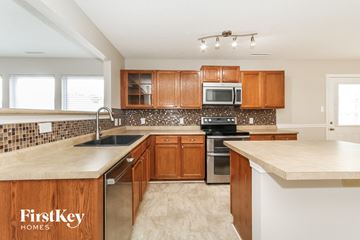 Mount Holly house for rent - a kitchen with wooden cabinets and a white counter top
