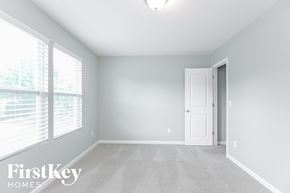 Monroe house for rent - a bedroom with a large window and a door to a closet