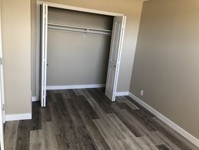Prince Albert house for rent - a bedroom with a closet and wood flooring