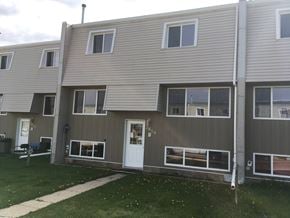 Prince Albert house for rent - the front of an apartment building with a white door