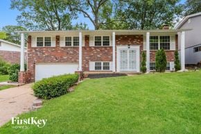 Saint Louis house for rent - A house with a brick facade and a white garage door.