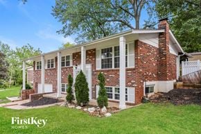Saint Louis house for rent - A brick house with a white door and windows.