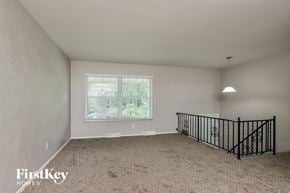 Saint Louis house for rent - A spacious room with a window and a bicycle rack.